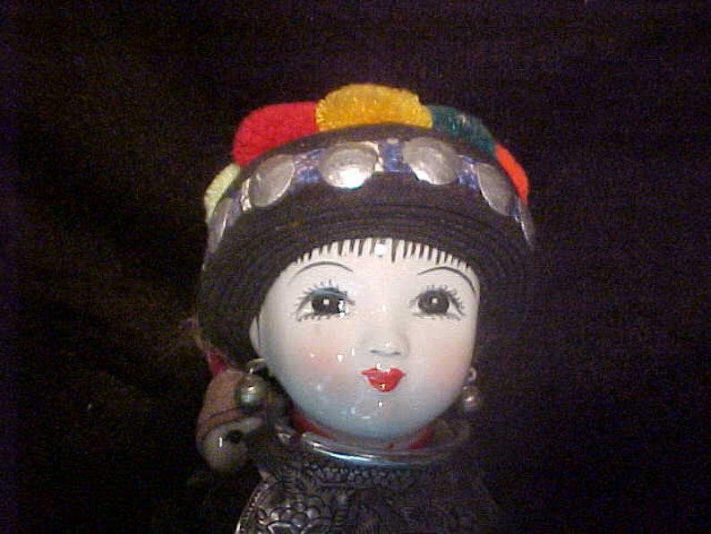 Traditional doll from Tibet or Nepal with local costume Ceramic