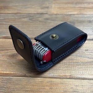 May include: A set of three ceramic mugs with a speckled, matte finish. The mugs are in shades of cream, light gray, and dark gray. Each mug has a simple, minimalist design, perfect for coffee or tea.