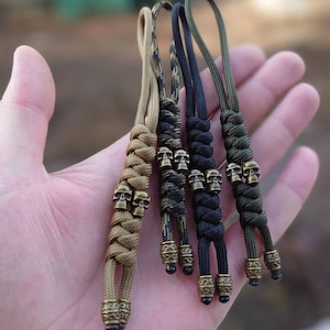 Paracord strap lanyard for a knife or keys with two skull beads