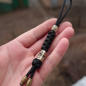 Paracord Lanyard, Viper "Templar Helmet", black.  Hand-molded brass bead