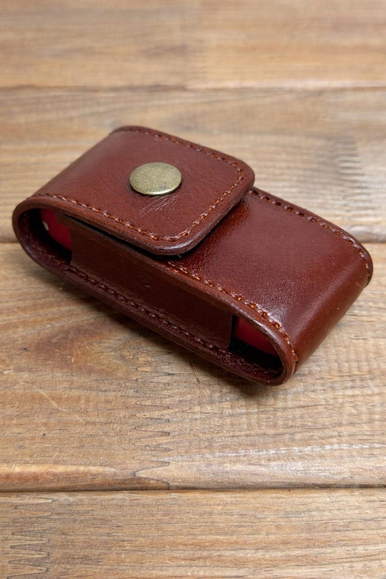 May include: A white ceramic mug with a black handle and the text "But First, Coffee" in a black, bold font. The mug is on a white surface. The mug is approximately 4 inches tall.