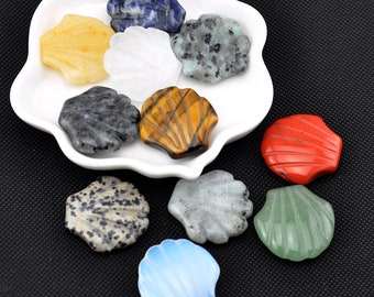 May include: Assortment of nine polished gemstone seashells in various colors, including blue, yellow, white, gray, brown, red, and green. The shells are displayed on a white plate.