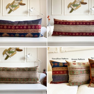 May include: Three long decorative pillows with different patterns. The pillows are on a white couch. The pillows are made of a woven fabric with a red, blue, and green color scheme. The pillows are labeled "NavyBlue Pattern", "Green Pattern", and "Terracotta Pattern".