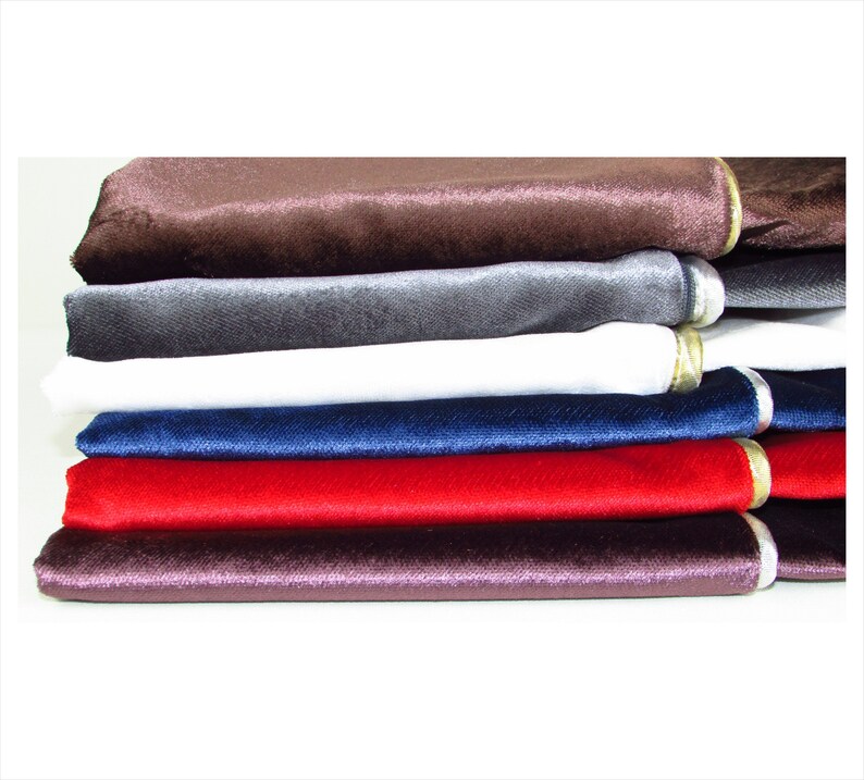 Puede incluir: Un conjunto de seis muestras de tela de terciopelo en varios colores, incluyendo marr&oacute;n, gris, blanco, azul marino, rojo y morado. Cada muestra tiene un ribete dorado en el borde.
