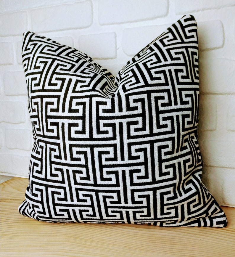 Upholstery fabric with a greek key pattern. It is a woven fabric, not a print. Black and white Geometric pattern pillowcase.