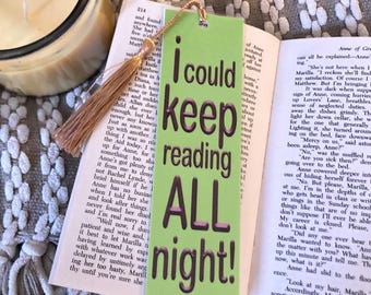 May include: Green and pink bookmark with the text "I could keep reading ALL night!" in a bold, black font. The bookmark has a tassel.