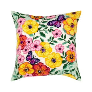 May include: A square throw pillow featuring a needlepoint design of vibrant yellow, orange, and pink flowers interspersed with green leaves and two purple butterflies on a cream-colored background, showcasing a detailed stitched texture.