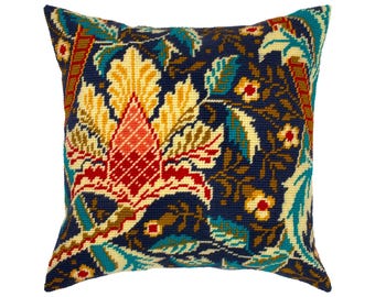 May include: A square needlepoint throw pillow featuring a dense botanical pattern on a dark navy blue background. The design includes large stylized flowers in shades of yellow, coral, and teal, accented by intricate green and brown foliage details.