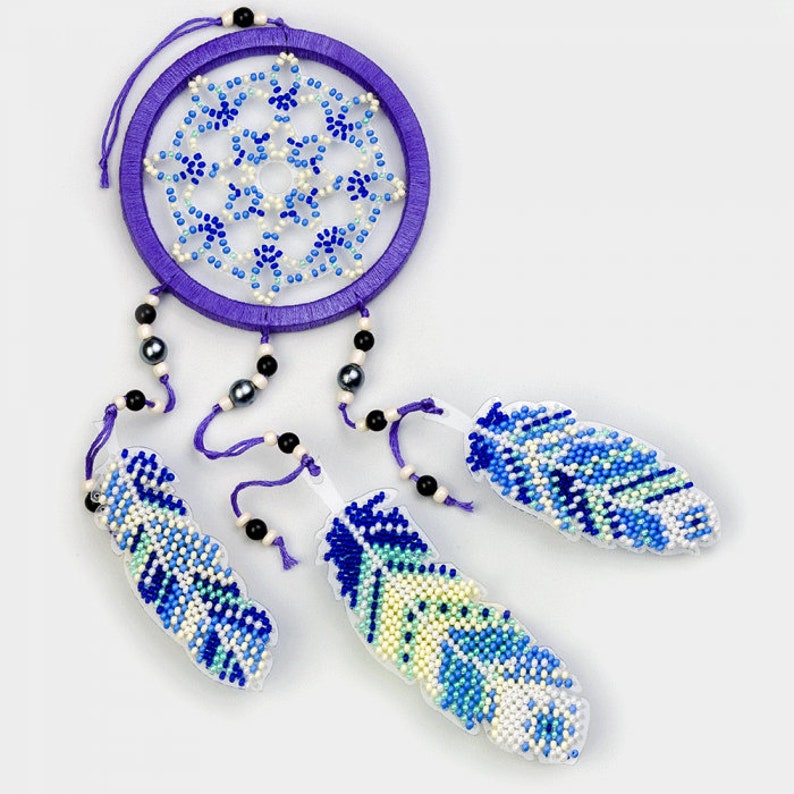 May include: A purple beaded dreamcatcher with white and blue beads. The dreamcatcher has three beaded feathers in shades of blue, white, and green.