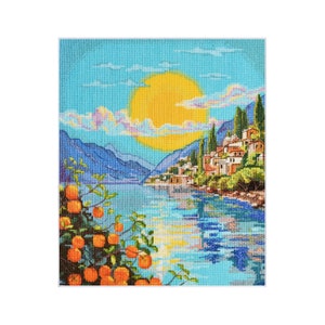 Puede incluir: Una bordado de punto de cruz que representa una escena pintoresca de un pequeño pueblo enclavado en una ladera con vistas a un lago azul tranquilo. El sol brilla intensamente en el cielo, proyectando un cálido resplandor sobre la escena. Los árboles verdes exuberantes y los vibrantes árboles frutales naranjas añaden belleza al paisaje.