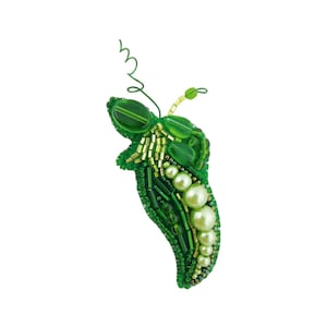 May include: A green beaded pea pod with a stem made of wire. The pod is decorated with green, gold, and white beads.