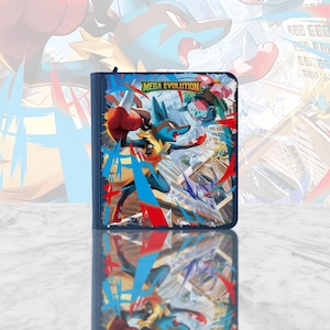 May include: A dark blue trading card binder featuring a Mega Evolution graphic on the front cover. The artwork displays a blue and yellow Lucario character in a dynamic pose, with the text Mega Evolution printed in yellow above the character.