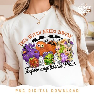 May include: White t-shirt with a graphic design of three witches holding coffee cups. The text on the shirt reads "This Witch Needs Coffee Before Any Hocus Pocus".