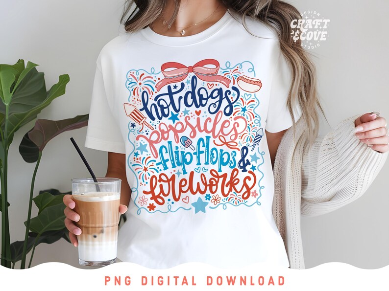 May include: White t-shirt with a colorful graphic design featuring the words "hot dogs, popsicles, flip flops & fireworks" in a playful font. The design includes illustrations of a hot dog, popsicle, and fireworks.