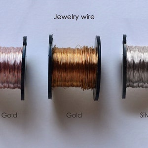 May include: Three spools of jewelry wire, one each in rose gold, gold, and silver.