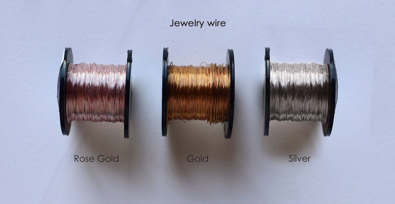 May include: Three spools of jewelry wire, one each in rose gold, gold, and silver.