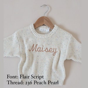 Chunky knit oversized fit sweater with confetti color specks and custom large machine embroidery. Thread color and name or saying of choice is completely personalizable. Modern, neutral, and minimal design for baby, toddler, and kids.