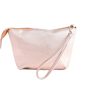 May include: A rose gold cosmetic bag with a zipper closure and a detachable strap.