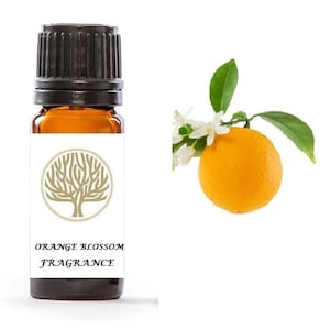 May include: A small amber glass bottle with a black cap and a white label. The label has a gold tree design and the text "ORANGE BLOSSOM FRAGRANCE". A single orange with white blossoms is shown on the right side of the image.