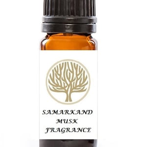 Può includere: Un piccolo flacone di vetro marrone con un tappo nero. L'etichetta è bianca con un disegno di albero dorato e il testo "SAMARKAND MUSK FRAGRANCE".