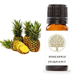 May include: A brown glass bottle with a black cap, labelled "Pineapple Fragrance". The bottle is sitting in front of three whole pineapples and a few pineapple slices.