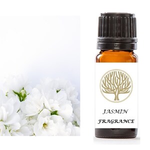 May include: A brown glass bottle with a black cap and a white label. The label has a gold tree design and the text "JASMINE FRAGRANCE".