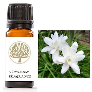 Op de afbeelding: Een klein bruin glazen flesje met een zwarte dop, met het label "TUBEROSE FRAGRANCE". Het flesje staat voor een witte bloem met groene bladeren.