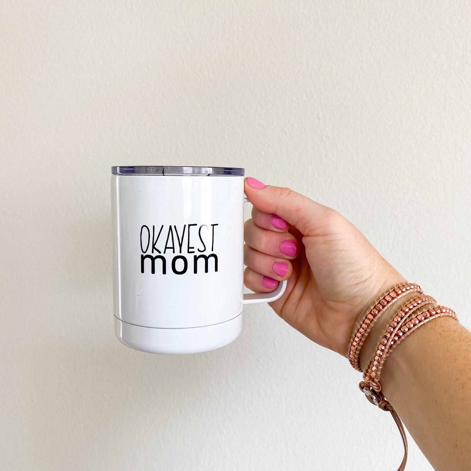 okayest mom travel mug with hand holding