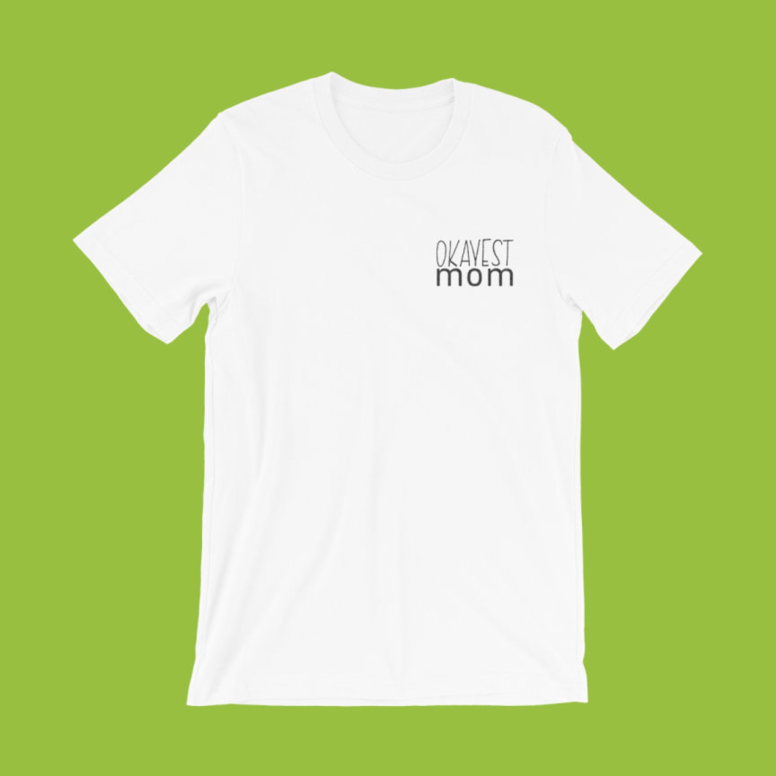 Okayest Mom logo pocket tee with green background