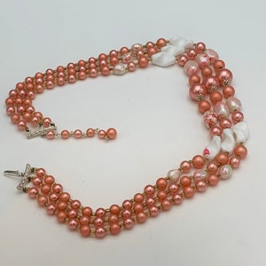 Collier japonais signé trois rangs de perles de verre d'art blanc et pêche, fermoir en argent et rallonge de perle de séparation
