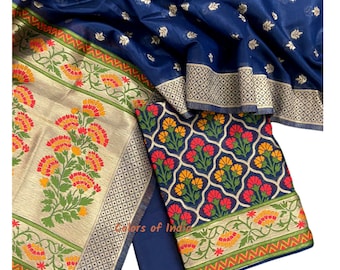May include: A blue and gold fabric with a floral pattern. The fabric is a traditional Indian design and is perfect for making a dress or a skirt.