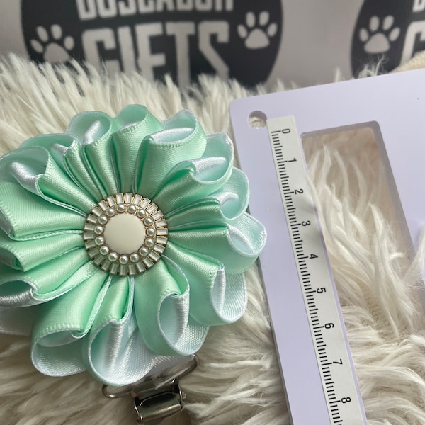 Folded rosette style flower made with pastel green and whiteribbon, centre piece, Dog Show exhibitor number ring clip with pinback finishing