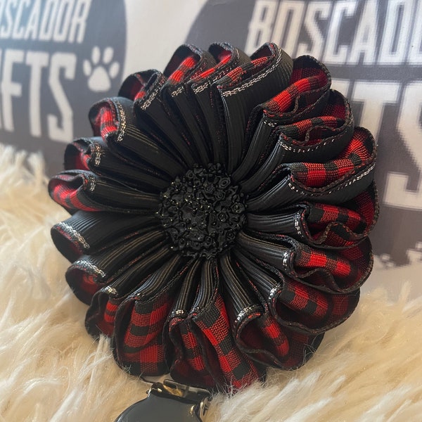 Folded rosette style flower made with red and black check ribbon, centre piece, Dog Show exhibitor number ring clip with pinback finishing