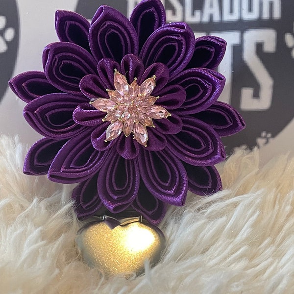 Folded ribbon style flower made with purple ribbon, pink centre piece, Dog Show exhibitor number ring clip with pinback finishing