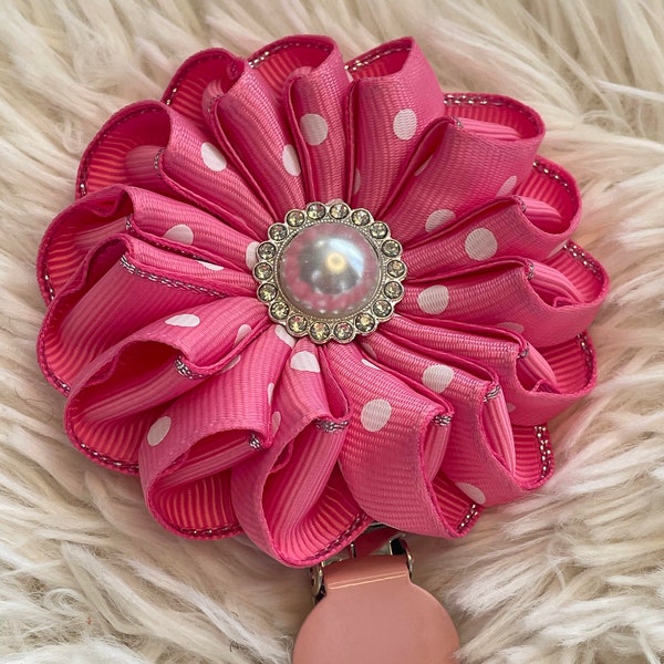 Folded rosette style flower made with pink polka dot ribbon, centre piece, Dog Show exhibitor number ring clip with pinback finishing