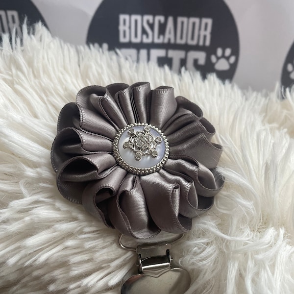 Folded rosette style flower made with grey ribbon, centre piece, Dog Show exhibitor number ring clip with pinback finishing