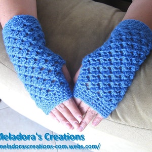 May include: A pair of blue crocheted fingerless gloves. The gloves are made with a lacy stitch pattern and are shown on a person's hands.