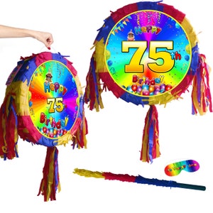 May include: A colourful 75th birthday pinata with a rainbow background and a yellow number 75. The pinata has a red, yellow, and blue tassel. It comes with a stick for hitting the pinata.