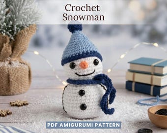 May include: A white crocheted snowman amigurumi featuring a light blue hat with a dark blue brim, a dark blue scarf, black button eyes, two black button torso accents, and an orange nose. The text Crochet Snowman and PDF AMIGURUMI PATTERN appear.