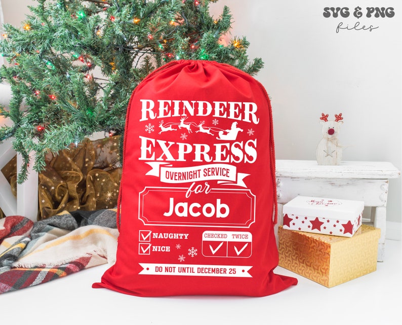 May include: A red drawstring gift sack featuring white text that reads Reindeer Express, Overnight Service for Jacob, Naughty, Nice, Checked Twice, and Do Not Until December 25. The design includes graphics of a sleigh, reindeer, and snowflakes.