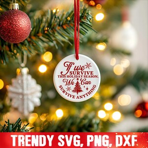 May include: White round Christmas ornament with red text that reads "If we survive this holiday season, we can survive anything". The ornament features a small Christmas tree and snowflakes.