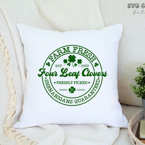 May include: White pillow with a green circle design that says "Farm Fresh" with a four-leaf clover and "Four Leaf Clovers" with the text "Est. 1929" and "Freshly Picked" and "Shenanigans Guaranteed."
