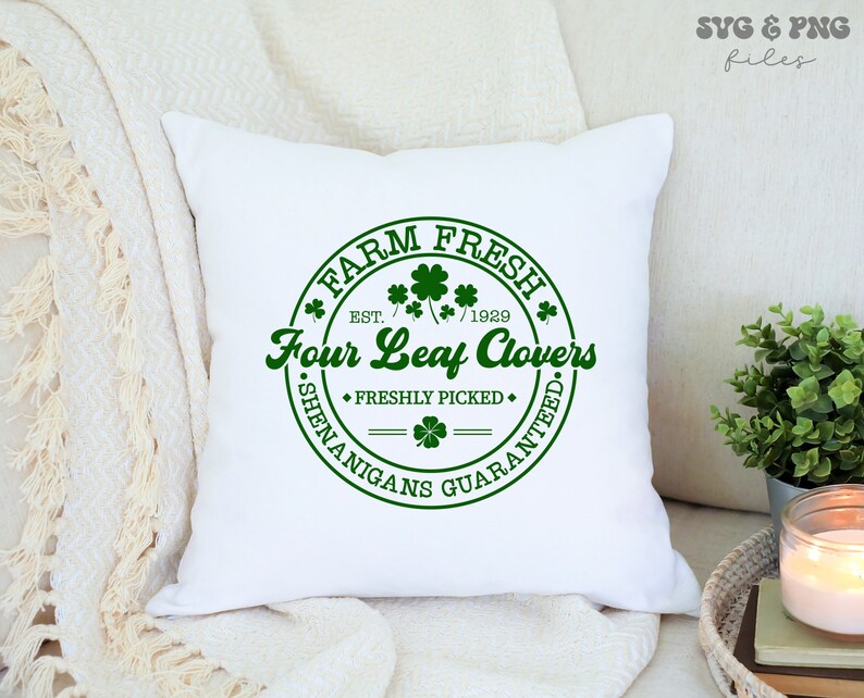 May include: White pillow with a green circle design that says "Farm Fresh" with a four-leaf clover and "Four Leaf Clovers" with the text "Est. 1929" and "Freshly Picked" and "Shenanigans Guaranteed."