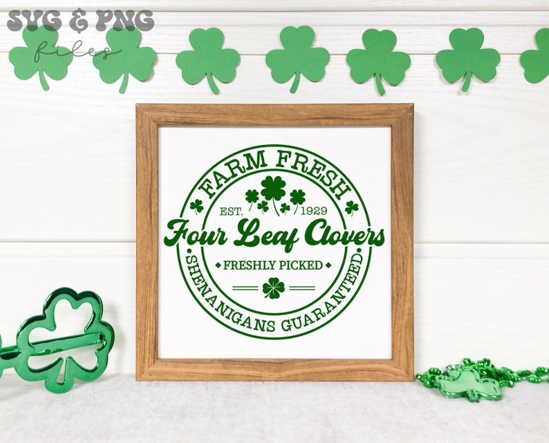 May include: A framed print with a green circle design that says "Farm Fresh Est. 1929 Four Leaf Clovers Freshly Picked Shenanigans Guaranteed".