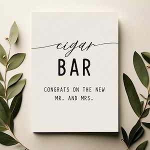 May include: A white card with black text that reads "cigar BAR CONGRATS ON THE NEW MR. AND MRS."