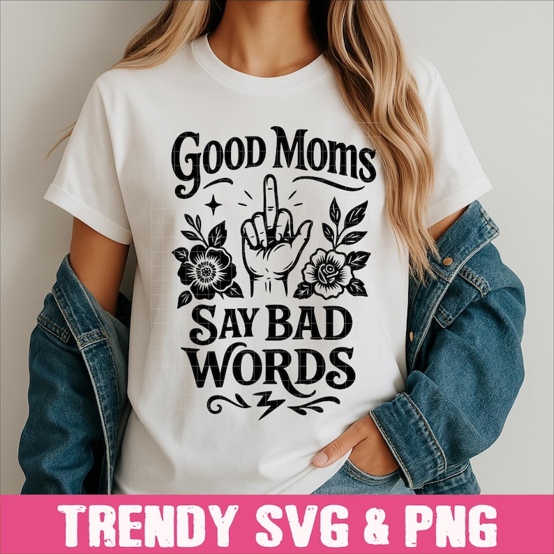 May include: White t-shirt with black text and graphic that says "Good Moms Say Bad Words". The graphic includes a hand giving the middle finger with flowers around it.
