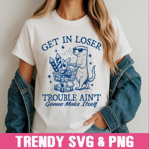 May include: White t-shirt with a blue graphic of a ferret wearing sunglasses and pushing a shopping cart full of fireworks. The text "Get in Loser, Trouble Ain't Gonna Make Itself" is printed on the shirt.