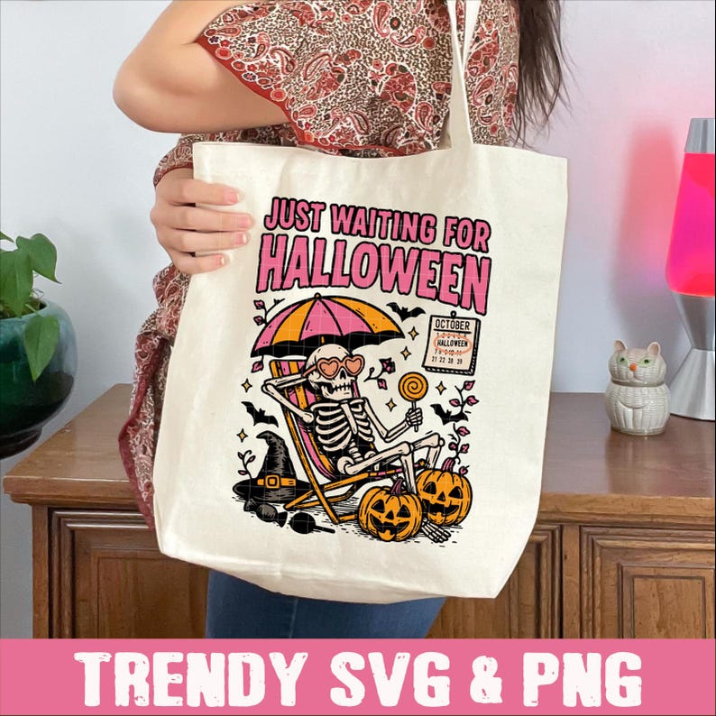 May include: Off-white tote bag with a Halloween-themed graphic. The design features a skeleton relaxing under a pink and orange umbrella, with pumpkins and the text "JUST WAITING FOR HALLOWEEN". Includes a calendar showing the date.