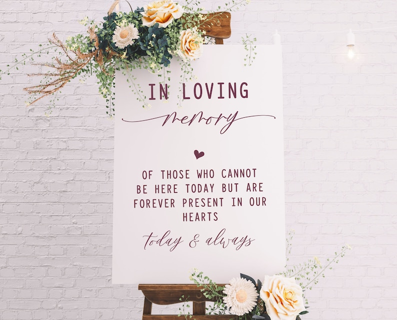 May include: White sign with the text "IN LOVING Memory" in burgundy script. Below the text is a small heart and the words "OF THOSE WHO CANNOT BE HERE TODAY BUT ARE FOREVER PRESENT IN OUR HEARTS today & always" in burgundy.