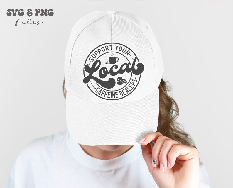 May include: White baseball cap with a black and white graphic that says "Support Your Local Caffeine Dealers" with a coffee cup and coffee beans in the design.